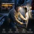 Man changing a truck tire at night with the HaloBeam headlamp lighting the wheel